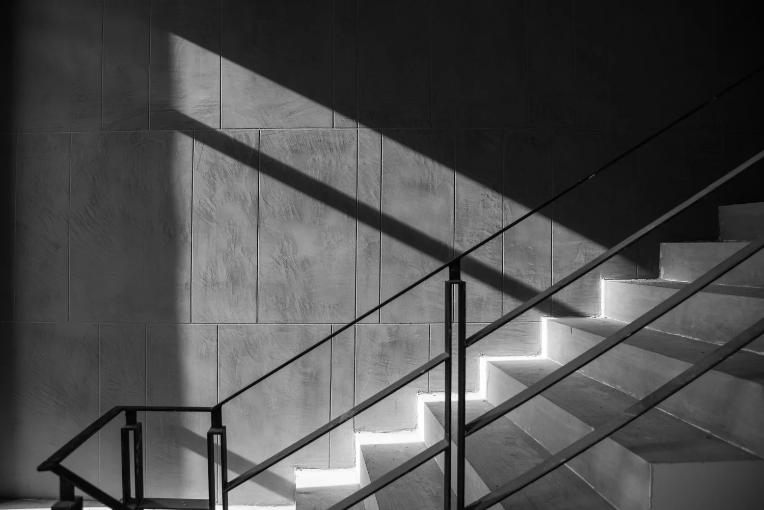 A staircase crossed by light and shadow