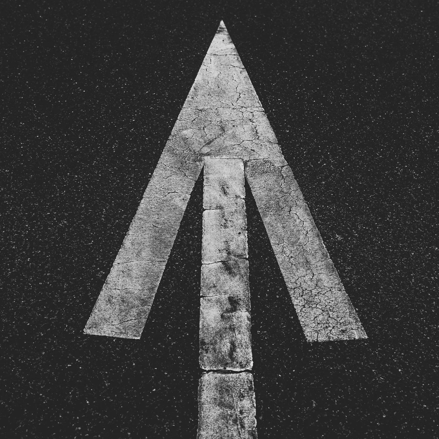 A painted arrow pointing forward on a road
