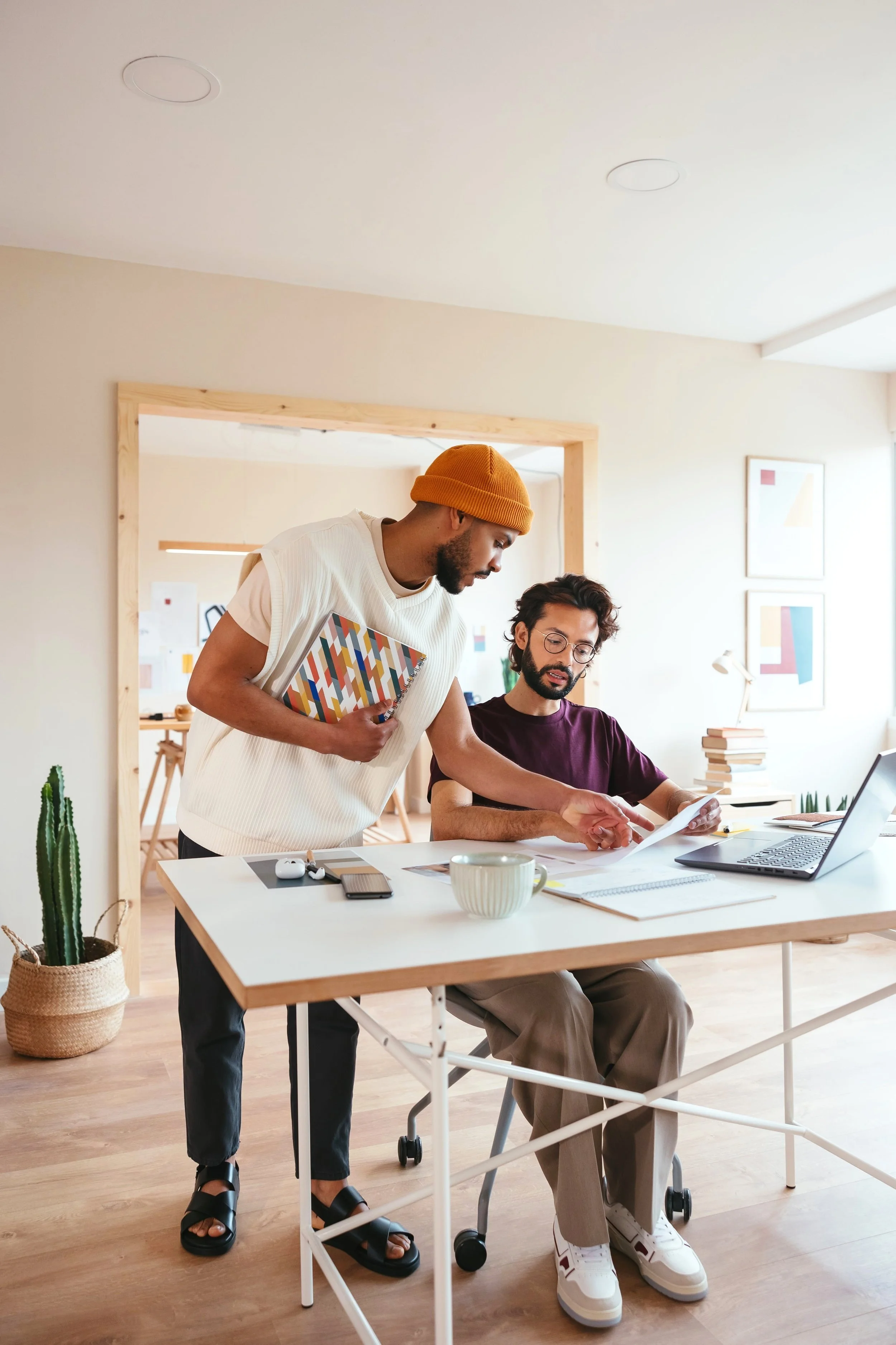Two colleagues collaborating in a creative workspace